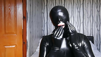 Latex-Clad Submissive Blindfolded, Gagged, And Masked